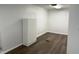 Spacious room with wood-look flooring, white walls, and storage cabinet at 823 N Noble St, Greenfield, IN 46140