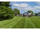 Expansive backyard view showcasing the lush lawn, above ground pool, and the outdoor area for leisure and activities at 8232 N Chaucer Ct, Columbus, IN 47201