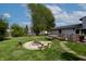 Backyard with a fire pit, patio furniture, and a well-maintained lawn, ideal for outdoor entertaining and relaxation at 8232 N Chaucer Ct, Columbus, IN 47201