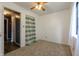 Bedroom with a ceiling fan, carpeted floors, and a closet with a striped curtain at 8232 N Chaucer Ct, Columbus, IN 47201