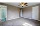 Bedroom featuring carpeted floors, ceiling fan, and an ensuite bathroom at 8232 N Chaucer Ct, Columbus, IN 47201