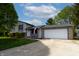 Charming home featuring a two-car garage, well-manicured lawn and patriotic American flag at 8232 N Chaucer Ct, Columbus, IN 47201