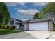 Lovely home boasting a two-car garage, spacious driveway and mature trees at 8232 N Chaucer Ct, Columbus, IN 47201