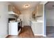 Galley kitchen featuring updated appliances, light countertops and ample cabinetry at 8232 N Chaucer Ct, Columbus, IN 47201