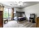 Bright bedroom with a window, bunk beds, fan and fun arcade machine at 8911 Hunters Creek Dr # 311, Indianapolis, IN 46227
