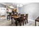 Cozy dining area featuring a classic table and chairs, adjacent to a well-equipped kitchen with bar stools at 8911 Hunters Creek Dr # 311, Indianapolis, IN 46227