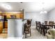 Bright dining area with modern chandelier, adjacent to the open kitchen with breakfast bar seating at 8911 Hunters Creek Dr # 311, Indianapolis, IN 46227