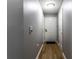 Bright hallway featuring modern laminate floors and a white door, creating a welcoming entrance at 8911 Hunters Creek Dr # 311, Indianapolis, IN 46227