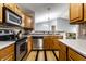 Open-concept kitchen with stainless steel appliances and seamless transition to the living area at 8911 Hunters Creek Dr # 311, Indianapolis, IN 46227