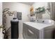 Well-equipped laundry room with washer, dryer, water heater and storage shelves at 8911 Hunters Creek Dr # 311, Indianapolis, IN 46227