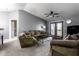 Spacious living room with neutral tones, comfortable seating, a ceiling fan, and balcony access at 8911 Hunters Creek Dr # 311, Indianapolis, IN 46227