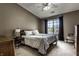 Cozy main bedroom with a ceiling fan, and view through a window to a neighborhood at 8911 Hunters Creek Dr # 311, Indianapolis, IN 46227
