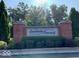 Welcome to Creekside Crossing! Community entrance sign framed by well-maintained landscaping at 8911 Hunters Creek Dr # 311, Indianapolis, IN 46227