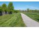 Take a stroll on the community's paved walking path surrounded by lush greenery and trees at 8911 Hunters Creek Dr # 311, Indianapolis, IN 46227