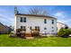 Backyard view featuring a deck, patio, white siding, and well maintained lawn at 8966 Wooster Ct, Fishers, IN 46038