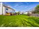 Spacious backyard with lush grass, mature trees, and a deck, ideal for outdoor entertaining and relaxation at 8966 Wooster Ct, Fishers, IN 46038