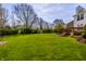 Large backyard featuring a lush lawn, mature trees, and a storage shed, perfect for outdoor activities at 8966 Wooster Ct, Fishers, IN 46038