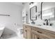 Modern bathroom featuring a double vanity with stylish wood cabinets, white countertops, and modern fixtures at 8966 Wooster Ct, Fishers, IN 46038