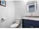 Charming half bathroom with a navy vanity, marble countertop, and modern gold faucet at 8966 Wooster Ct, Fishers, IN 46038