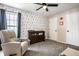 Cozy bedroom featuring a comfortable recliner, changing table, and custom wallpaper, creating a warm, inviting space at 8966 Wooster Ct, Fishers, IN 46038