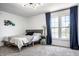 Bright bedroom featuring plush carpeting, a comfortable queen bed, and natural light from the double windows at 8966 Wooster Ct, Fishers, IN 46038