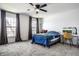 Bright bedroom featuring plush carpeting, a comfortable bed, natural light, and a workspace desk and chair at 8966 Wooster Ct, Fishers, IN 46038