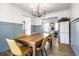 Elegant dining room with modern lighting, a wooden table, and stylish chairs at 8966 Wooster Ct, Fishers, IN 46038