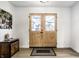 Inviting entryway with wood-framed glass doors, modern flooring, and a stylish console table at 8966 Wooster Ct, Fishers, IN 46038