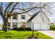 Charming two-story home with white brick, wood shutters, an attached two-car garage, and a well-manicured lawn at 8966 Wooster Ct, Fishers, IN 46038