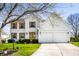 Charming two-story home with white brick, wood shutters, an attached two-car garage, and a well-manicured lawn at 8966 Wooster Ct, Fishers, IN 46038