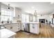 Bright kitchen featuring white cabinets, stainless steel appliances, and an open layout to the dining and living area at 8966 Wooster Ct, Fishers, IN 46038