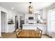 Beautiful kitchen with white cabinetry, stainless steel appliances, an island, and an adjacent dining area at 8966 Wooster Ct, Fishers, IN 46038