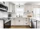 Modern kitchen with stainless steel appliances, white cabinets, quartz countertops, and subway tile backsplash at 8966 Wooster Ct, Fishers, IN 46038
