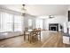 Inviting living area featuring a dining table, fireplace, ample windows, and modern flooring at 8966 Wooster Ct, Fishers, IN 46038