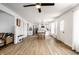 Bright open concept living room and kitchen with light hardwood flooring and modern ceiling fan at 8966 Wooster Ct, Fishers, IN 46038