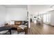 Bright living room featuring a comfortable leather couch, modern furnishings, and open access to the kitchen at 8966 Wooster Ct, Fishers, IN 46038