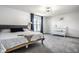 Calming main bedroom featuring a comfortable bed, a crib, and soft carpet flooring at 8966 Wooster Ct, Fishers, IN 46038