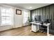Bright home office with a standing desk, natural light, and modern decor at 8966 Wooster Ct, Fishers, IN 46038