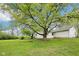 A spacious backyard features a large tree with plenty of space for outdoor enjoyment at 90 S Morgantown Rd, Greenwood, IN 46142