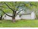 A beautiful tree graces the spacious backyard, perfect for enjoying outdoor activities at 90 S Morgantown Rd, Greenwood, IN 46142