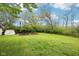 Spacious backyard with green lawn and utility shed, offering plenty of room for outdoor activities at 90 S Morgantown Rd, Greenwood, IN 46142