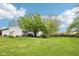 Expansive backyard with green lawn and mature trees offering ample space for recreation and relaxation at 90 S Morgantown Rd, Greenwood, IN 46142