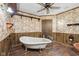 This bathroom features a claw foot tub, wood-paneled walls, decorative wallpaper, and modern fixtures at 90 S Morgantown Rd, Greenwood, IN 46142
