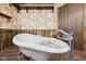 Retro bathroom design with unique wallpaper, a clawfoot tub, and wood accents at 90 S Morgantown Rd, Greenwood, IN 46142