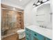 Updated bathroom boasts a modern vanity, stylish lighting, and a shower with a built-in seat at 90 S Morgantown Rd, Greenwood, IN 46142