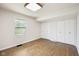 Bright bedroom with closet space, a large window, and light hardwood floors for comfortable living at 90 S Morgantown Rd, Greenwood, IN 46142