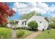 Exterior view showcasing the home's side entrance, landscaping, and charming details at 90 S Morgantown Rd, Greenwood, IN 46142