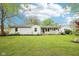 Charming one-story home featuring a large front yard, white siding, and inviting porch at 90 S Morgantown Rd, Greenwood, IN 46142