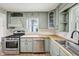 An updated kitchen features light green cabinetry, stainless steel appliances, and butcher block countertops at 90 S Morgantown Rd, Greenwood, IN 46142