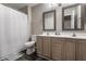 A bright bathroom with double sinks, mirrors, and vanities at 9575 Thradd St, Fishers, IN 46038